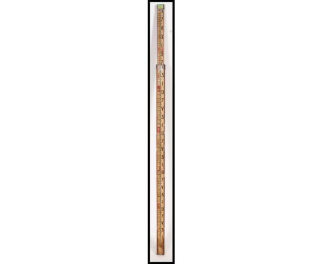 A vintage oak surveyors measuring stick with central notation rule on white ground with blank batons and numbers