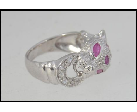 A silver Cartier style panther ring being inset with semi-precious stones. Total weight 5.5g / Size k.5 RS L