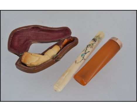 A 9ct gold cigar cheroot hallmarked for Birmingham 1914 by AF&Co together with a small cased meerschaum pipe carved in the fo