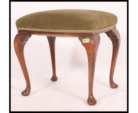 A early to mid 20th century piano stool, having an over stuffed pad, raised on cabriole legs H50xW52xD40cm