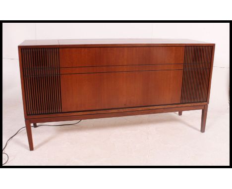 A vintage / retro teak cased 20th century Bush radiogram, having a central hinged opening lifting to reveal a four speed reco