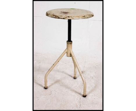 A retro / vintage industrial machinist stool, having a circular pad, raised on tubular frame, having an hight  adjustable rev