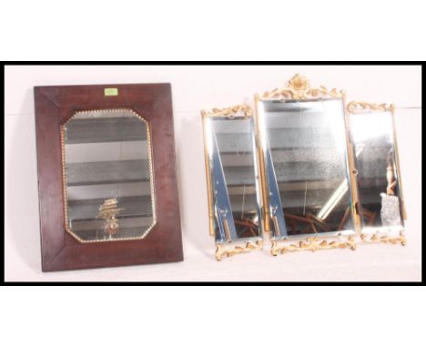 A mid 20th century triptych Louis style mirror along with a Victorian oak framed bevel mirror with a brass sing candlestick s