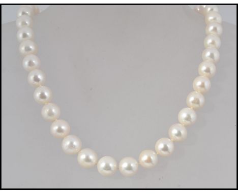 A fine cultured pearl necklace, circa 20th century having gilded silver finial ball clasp. Total weight 71g