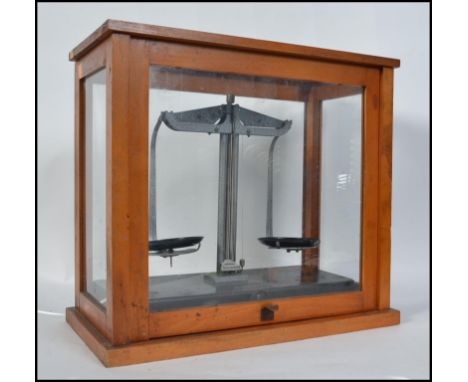 A cased set of mid century Scientific scales. The scales complete and in the original glass and teak wood case H40cm