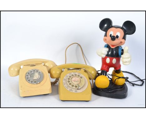 A retro vintage Mickey Mouse telephone together with a mustard coloured BT ring dial telephone and another ( 3 total ). Measu