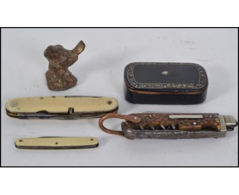 A 19th century papier mache snuff box of rectangular form together with a collection of penknives and a small brass figurine 