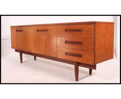 A large vintage mid century G-Plan style teak sideboard having 3 drawers to the right with double door cupboard to the left a