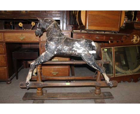 A late 19th century believed Lines Brothers or Brassington & Cooke rocking horse. The original glider base with plaster on wo