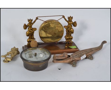 A mixed lot of metalware - vintage Pixie table gong with oak base, large crocodile nutcrackers, Pixie knocker and an old bras