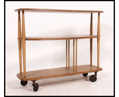 An early 1960's / 1970's Ercol beech and elm low room divider raised on the original wheel castors designed by Lucian Ercolan