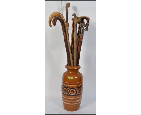 A retro 1970's  West German stick stand / vase complete with a collection of walking sticks