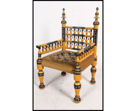 A stunning Indian handpainted yellow opium / hall chair raised on turned legs with overstuffed velour needlepoint seat and  s