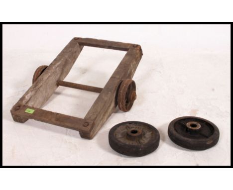 A vintage industrial small set of wheels / dolly trolley, possibly ex Railway along with a set of loose wheels 60x49cm