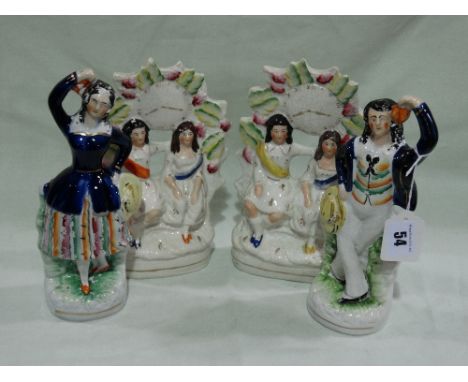 A Pair Of Staffordhsire Pottery Dancing Figures Together With Two Staffordshire Pottery Clock Groups