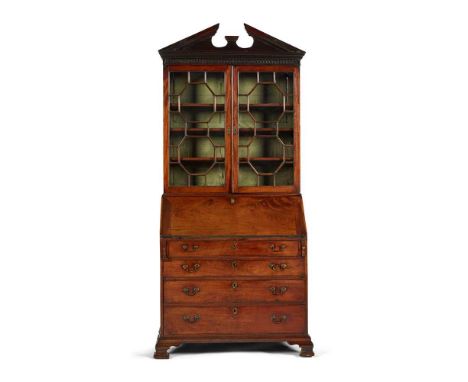 EARLY GEORGE III MAHOGANY BUREAU BOOKCASE MID 18TH CENTURY the dentil moulded broken-arch pediment above a blind fret frieze 
