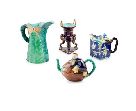 COLLECTION OF ENGLISH MAJOLICA LATE 19TH CENTURY comprising a teapot and cover, probably Holdcroft, modelled as a Chinese boy