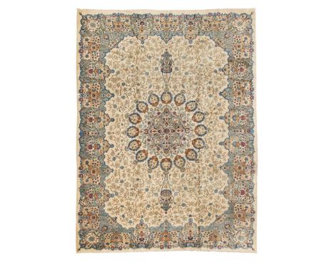 KASHAN CARPET CENTRAL PERSIA, MID 20TH CENTURY the cream field with light blue medallion suspending pendants, within blue and