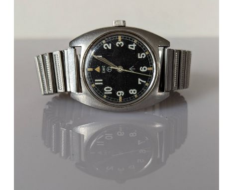 A CWC British military issue stainless steel wristwatch, 1979, with black dial, military arrow, circled T indicating the use 