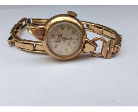 A 1950s ladies Rotary manual wristwatch with alternating Arabic and baton markers in a 9ct yellow gold case and elastic strap