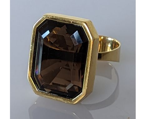 A smokey topaz dress ring in yellow gold, stamped 750 and testing for 18ct, size W, 26.2g