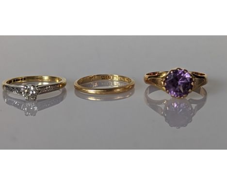 A solitaire diamond ring on a white and yellow gold setting, diamond 0.20 carats; a gold wedding band and an amethyst dress r