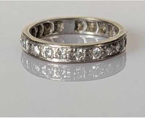 A white gold and diamond eternity ring with twenty round-cut diamonds, total diamond weight approximately 1.0 carats, unmarke