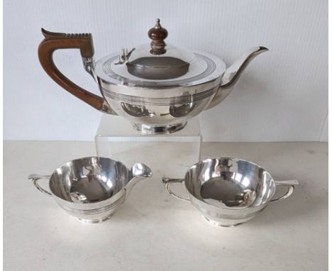 An Edwardian silver tea service of squat form with reeded bands, carved wood handle and knop, hallmarked for Mappin & Webb, S