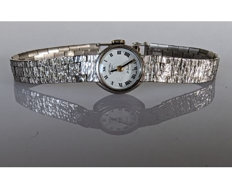 A 1960s ladies Rotary manual wristwatch with Roman numerals in an oval white gold case and textured strap, clasp faulty, hall