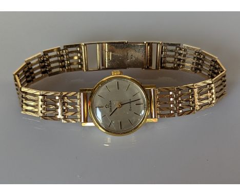 An Omega ladies Geneve manual dress watch with baton markers, champagne dial, 18mm, stainless steel case with a 9ct yellow go