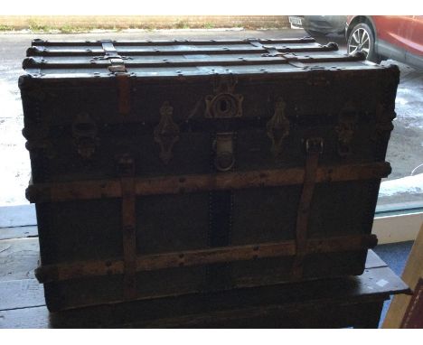A hinged top canvas trunk. Est. £30 - £40.