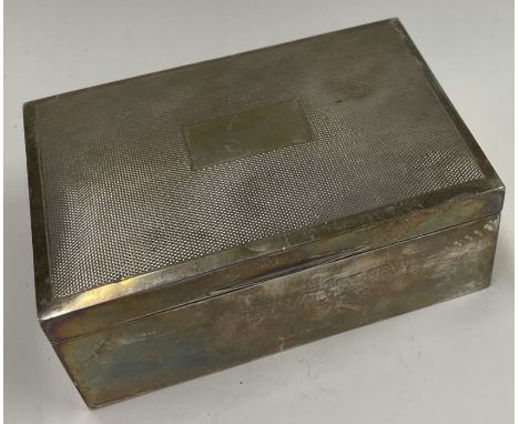 An engine turned silver cigar box. Birmingham 1950. By H Bros. Est. £100 - £150.