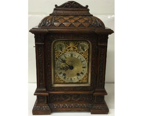 A good quality carved oak and brass mounted bracket clock with gilt dial. Est. £100 - £200.