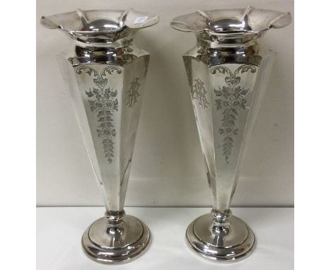 A large pair of decorative silver vases. Sheffield 1910. By Fenton Brothers Ltd. Approx. 644 grams. Est. £200 - £300.