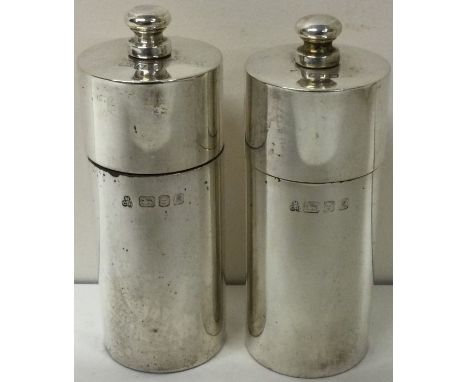 A pair of contemporary silver pepper grinders. London 1991. By M C Hersey &amp; Son Ltd. Approx. 285 grams. Est. £100 - £150.