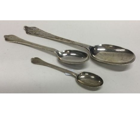 A group of three Georgian style silver rat tail spoons. London. Approx. 108 grams. Est. £30 - £40.