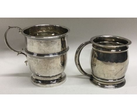 An Edwardian silver christening mug together with one other. Approx. 79 grams. Est. £30 - £40.