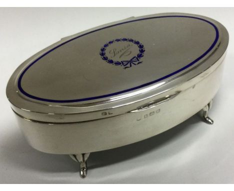 A silver trinket box with blue enamel cartouche and surround. Birmingham 1919. Approx. 239 grams. Est. £120 - £150.