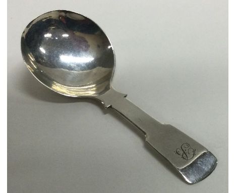 A Georgian silver fiddle pattern caddy spoon. Birmingham. By GU. Approx. 10 grams. Est. £30 - £40.