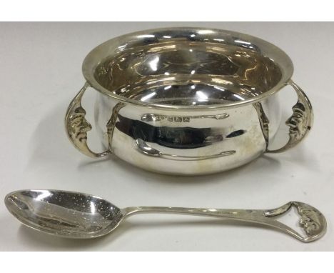 A cased silver christening bowl and spoon with 'Man on the Moon' design. Birmingham 1946. By Aaron Lufkin Dennison. Approx. 1