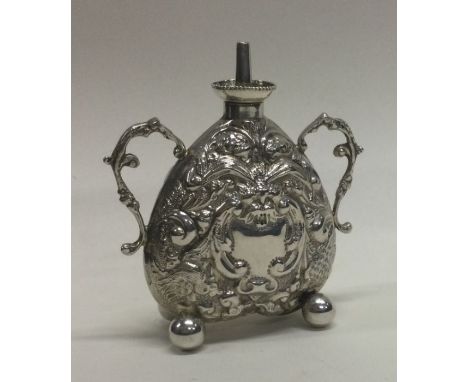 A small silver lamp decorated with flowers and leaves. Approx. 50 grams. Est. £60 - £80.