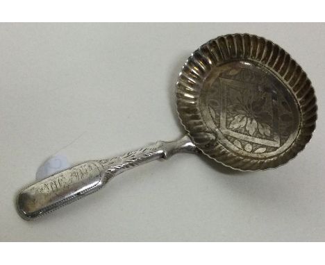 A silver caddy spoon with oval fluted bowl and hollow handle. Birmingham 1818. By IT. Approx. 7 grams. Est. £20 - £30.