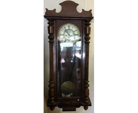 A large mahogany wall clock with white enamelled dial. Est. £50 - £80.