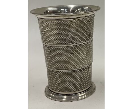 An engine turned collapsible silver beaker. Maker's mark only to base. Approx. 79 grams. Est. £150 - £200.