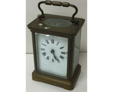 A small brass carriage clock with white enamelled dial. Est. £20 - £30.