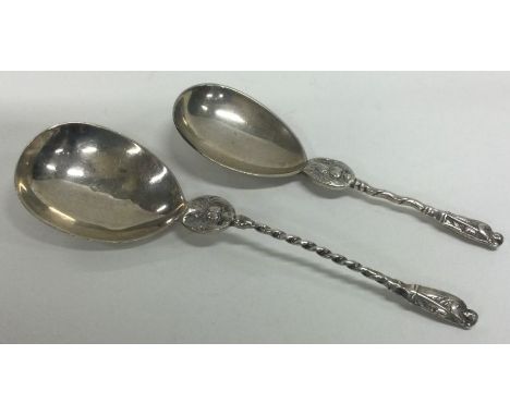 An unusual silver caddy spoon together with one other. London. Approx. 33 grams. Est. £20 - £30.
