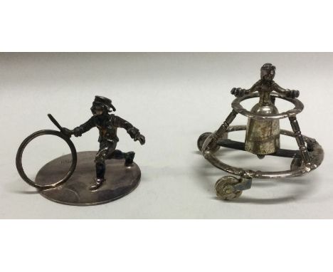 A novelty silver table toy in the form of a child together with one other. Approx. 38 grams. Est. £30 - £50.