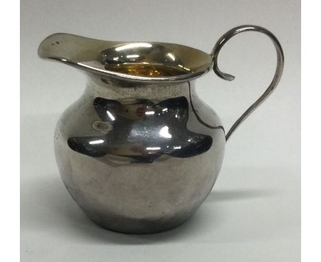 A small tapering silver cream jug together with one other. Approx. 50 grams. Est. £30 - £40.