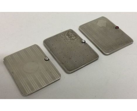 Three good silver stamp slides with engine turned decoration. Approx. 58 grams. Est. £40 - £60.