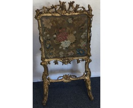 A gilt fire screen. Est. £50 - £80.